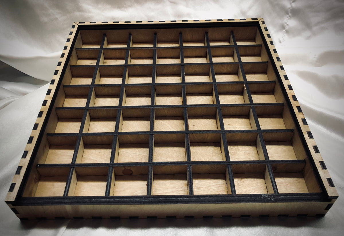 A 13" x 13" laser-cut typeset drawer with a grid of cubby spaces. The internal dividers  do not reach the full height of the drawer, allowing for ample clearance for standard typesets.