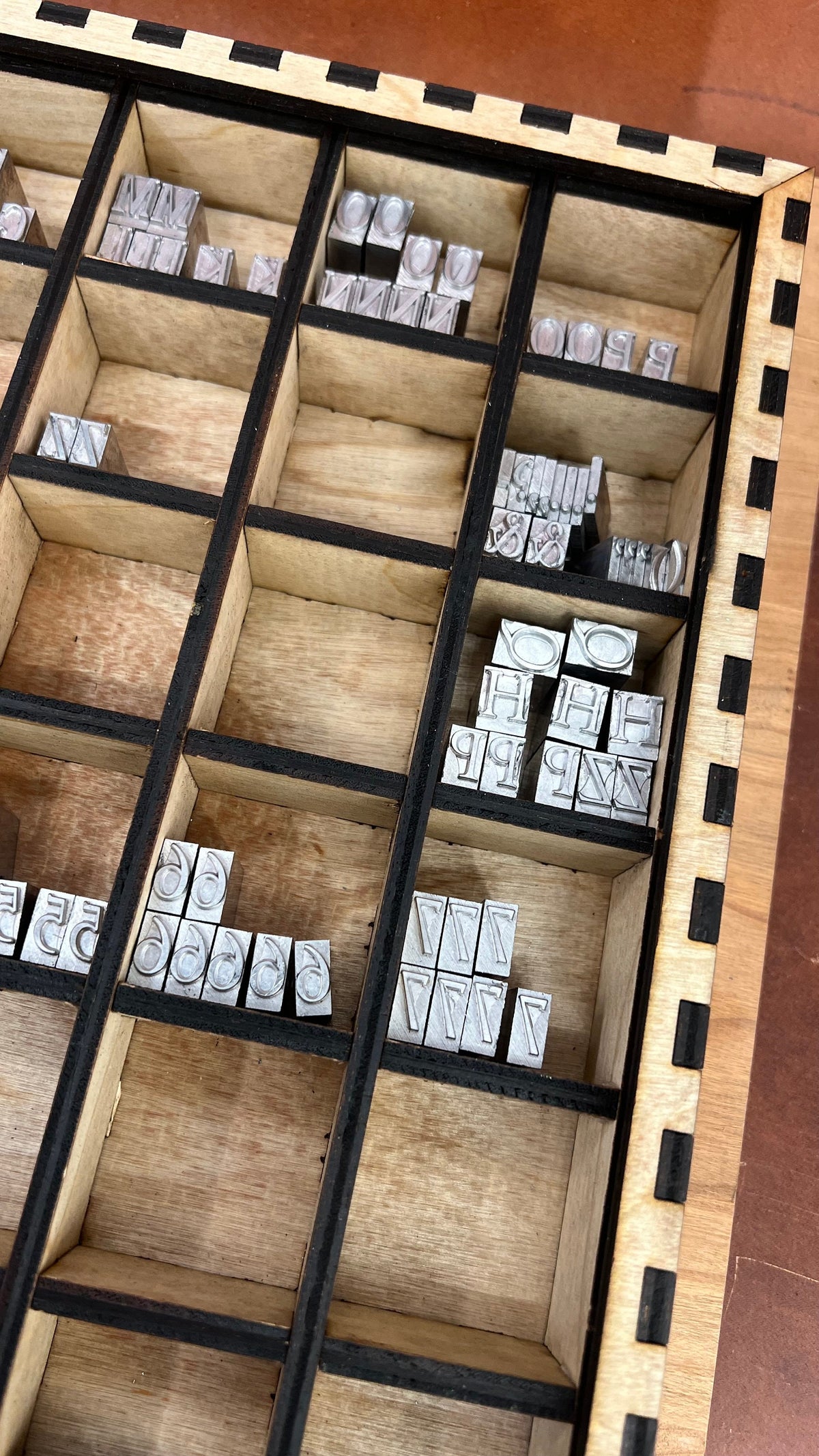 13x13 Typeset Drawer Organizer with partitions, ideal for organizing typesets, craft supplies, and small parts. Features durable, laser-cut wood construction with multiple compartments for efficient storage and easy access.