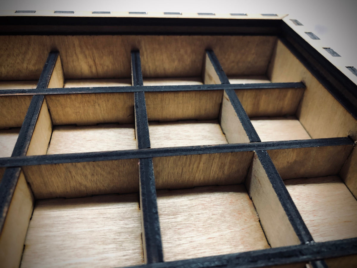 Close-up of a 13 x 13 inch laser-cut wooden typeset drawer with 3/4 inch tall internal dividers. Perfect for organizing 1 inch typesets, crafting supplies, or small collectibles. Precision-crafted for ample storage and a sleek, functional design.